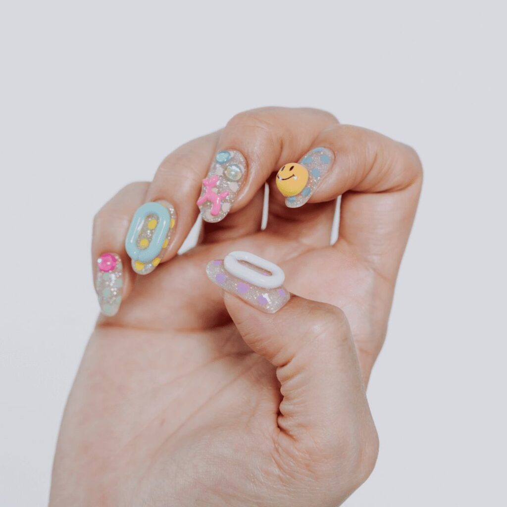 Resin charms on nail enhancements